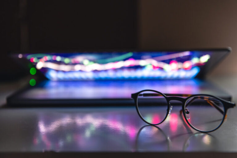 laptop-with-graphs-statistics-glasses-table