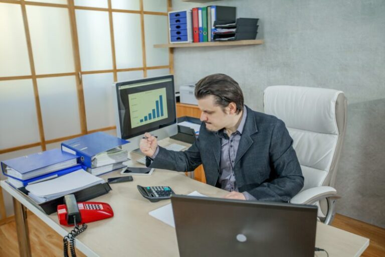 Young businessman working from his office - the concept of hard work and failure